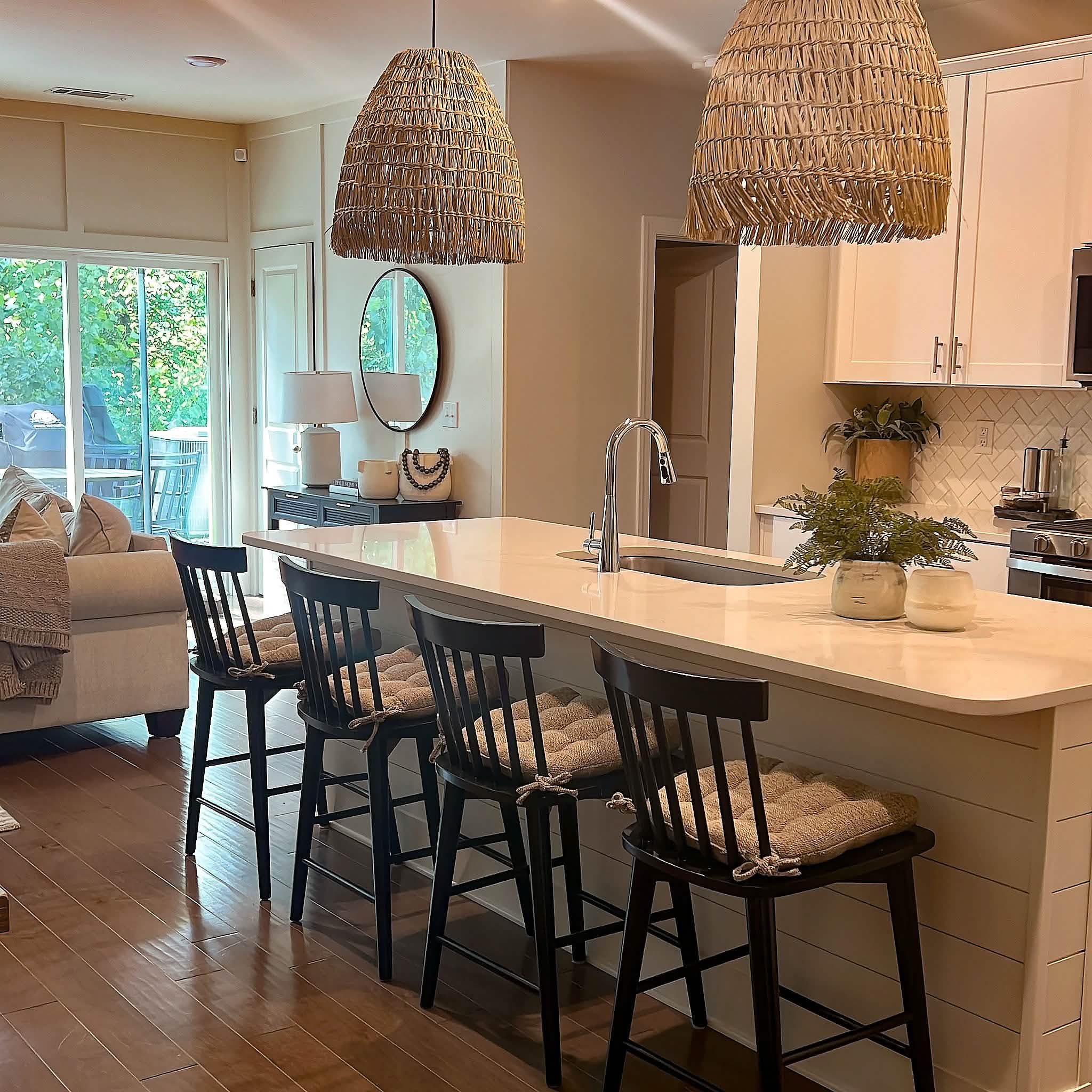 neutral colored kitchen chair pads on black dining chairs at a contemporary kitchen island bar