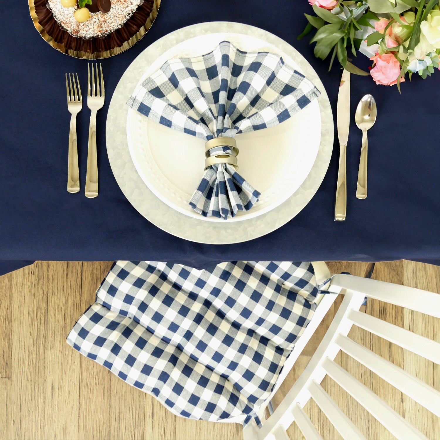 table setting with blue checkered napkins and chair cushion