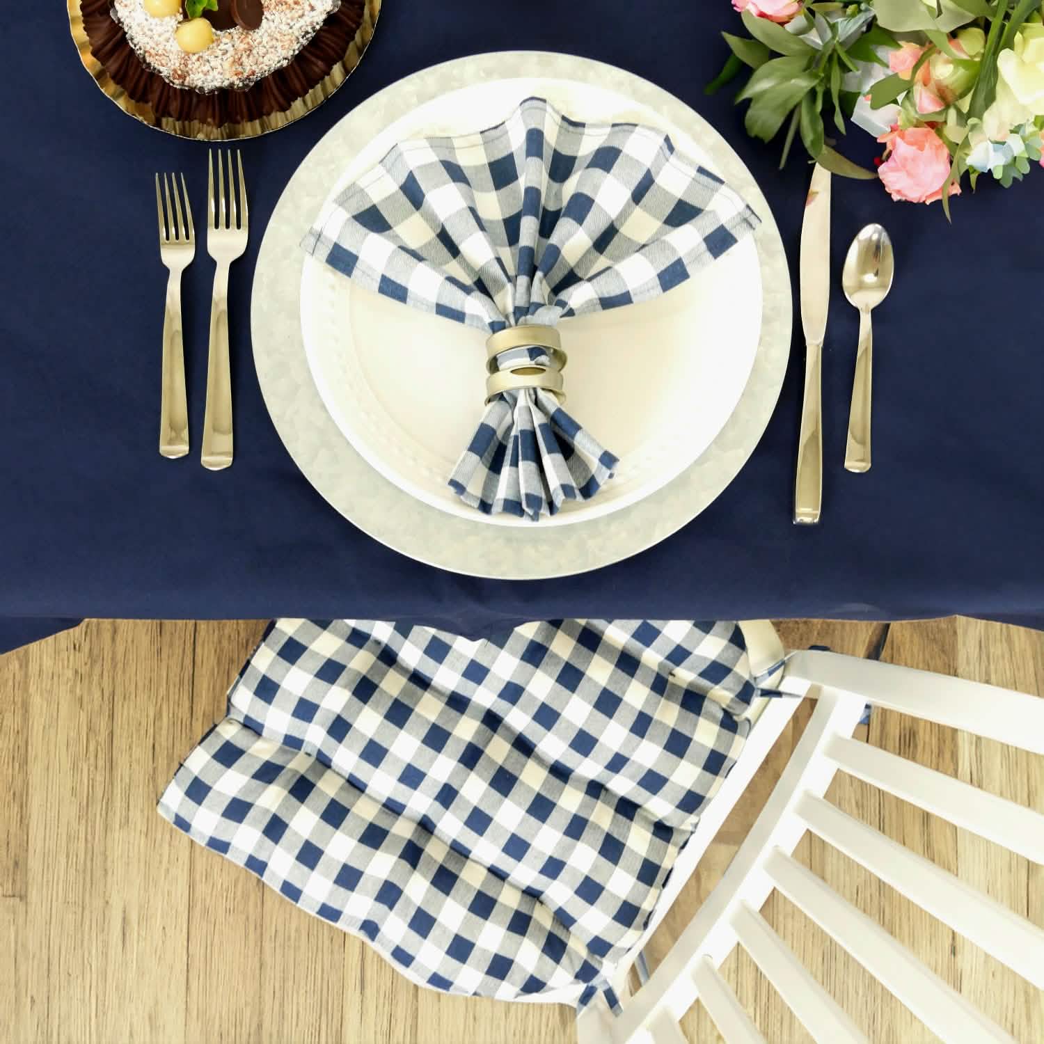 table setting with blue checkered napkins and chair cushion