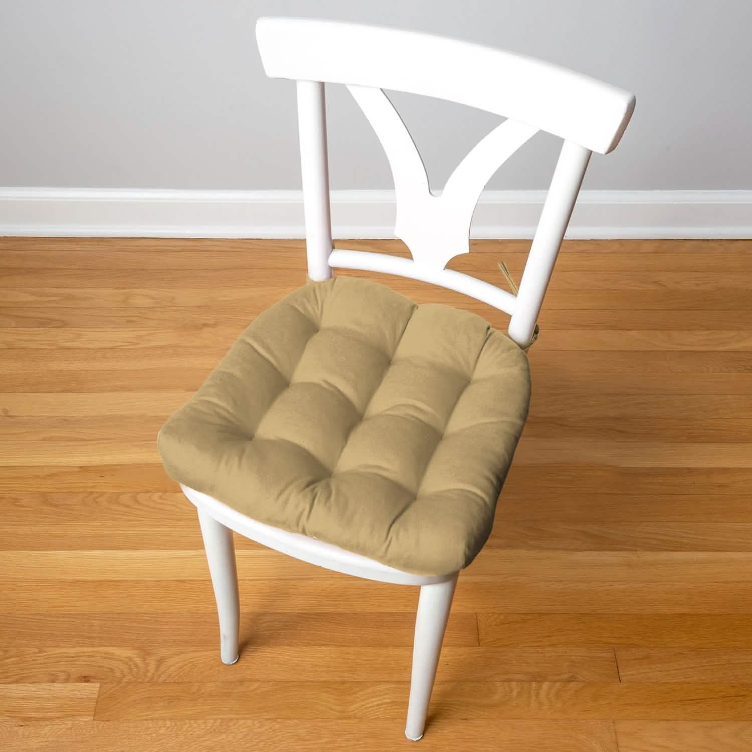 Tan cotton duck dining chair pad on white mid-century modern dining chair