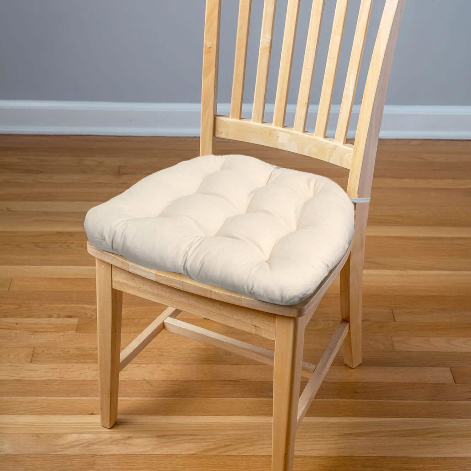 unbleached cotton dining chair cushions on a natural dining chair in a contemporary dining room