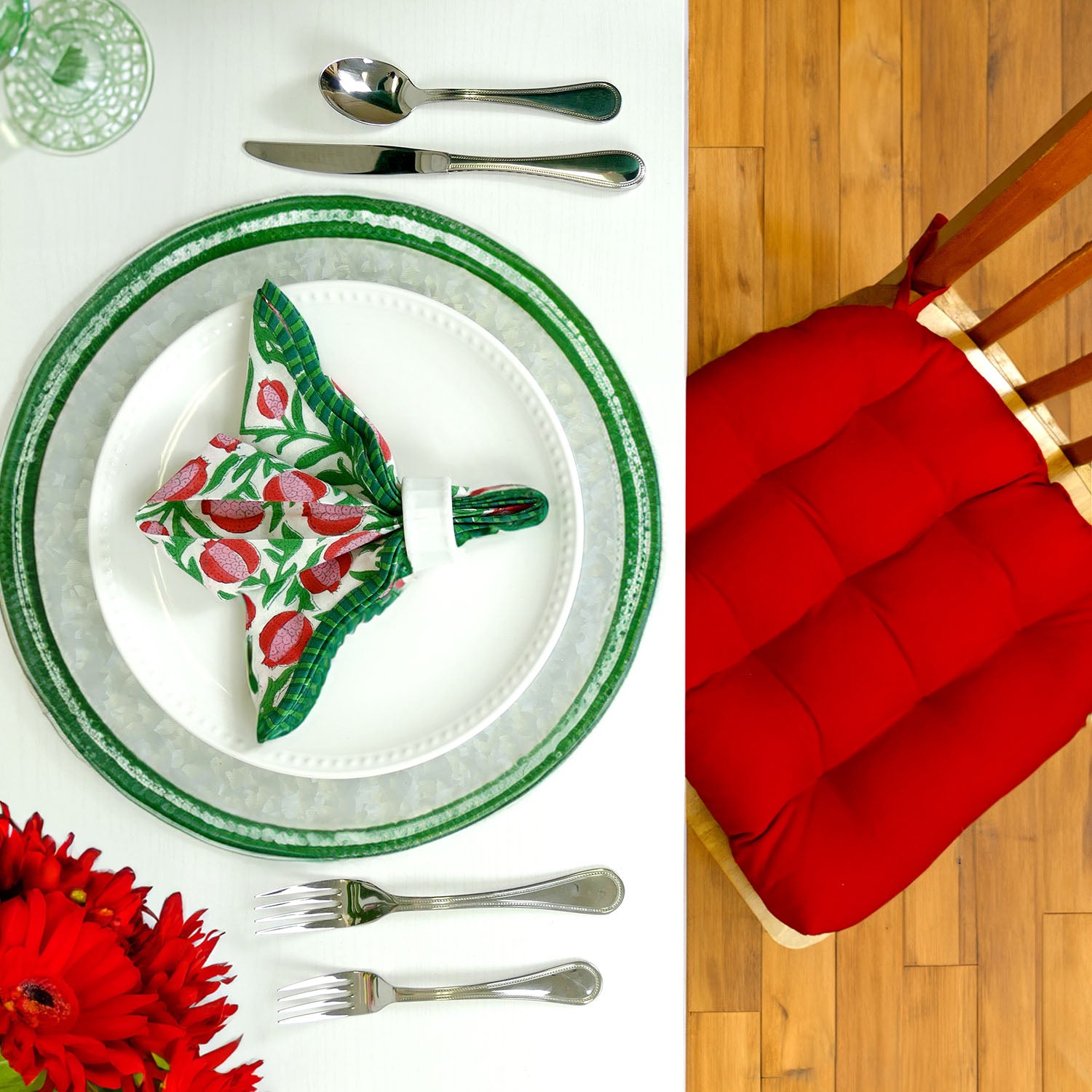 cloth napkin with christmas design, and a red cushion on a wooden chair