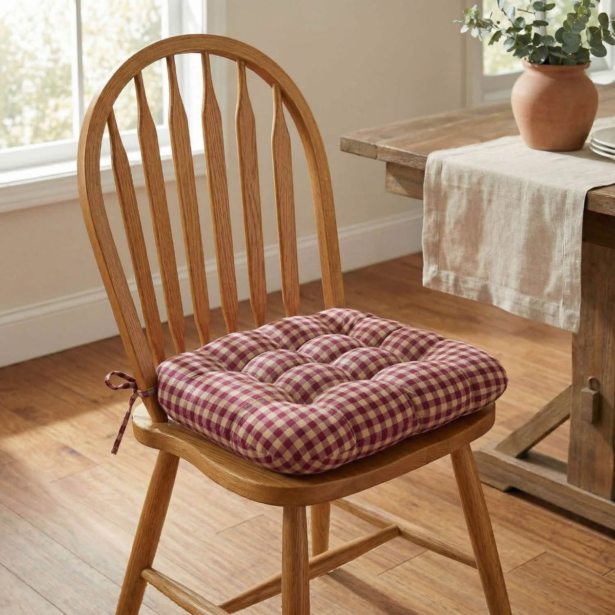 red and tan checked dining chair cushion on windsor dining chair