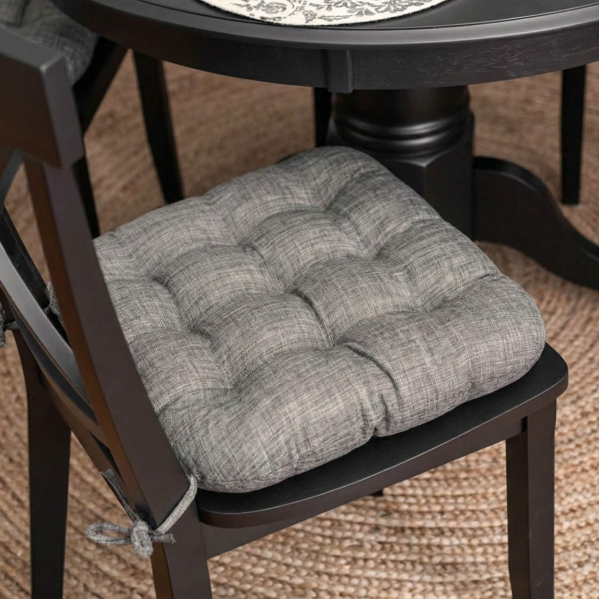 grey dining room chair cushion with linen texture on black dining set