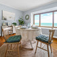 coastal dining room with turquoise dining chair pads on natural wooden dining chairs