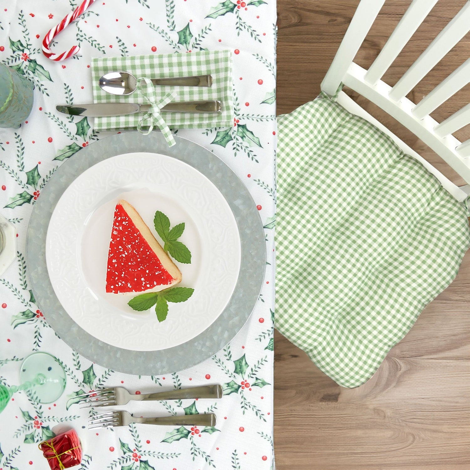 Christmas-themed table setting with christmas dining chair cushion and matching napkin and festive decor
