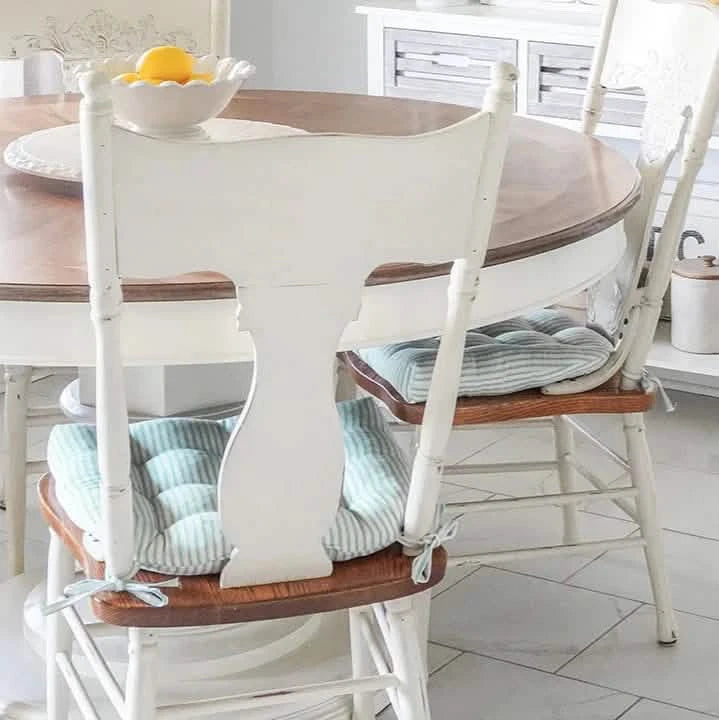 ticking stripe aqua chair pads on white wood chair at round table,