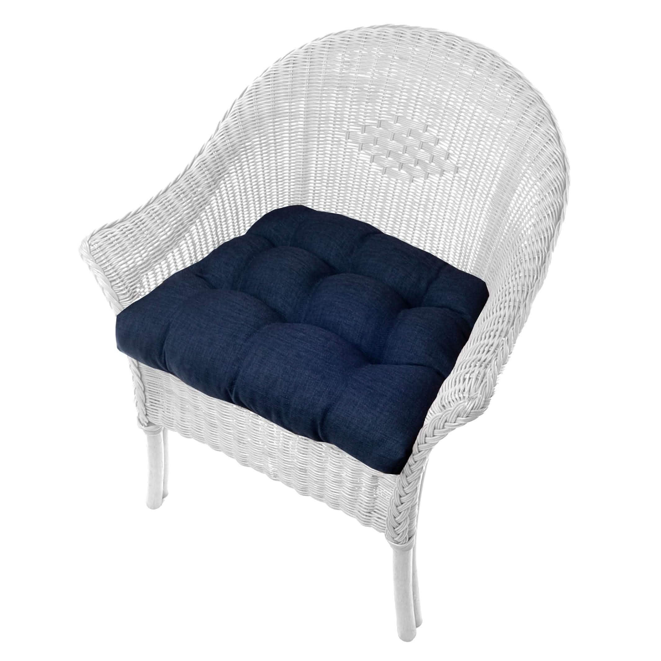 Rave Indigo blue patio chair cushion on wicker outdoor chair showing deep blue color and tufted design