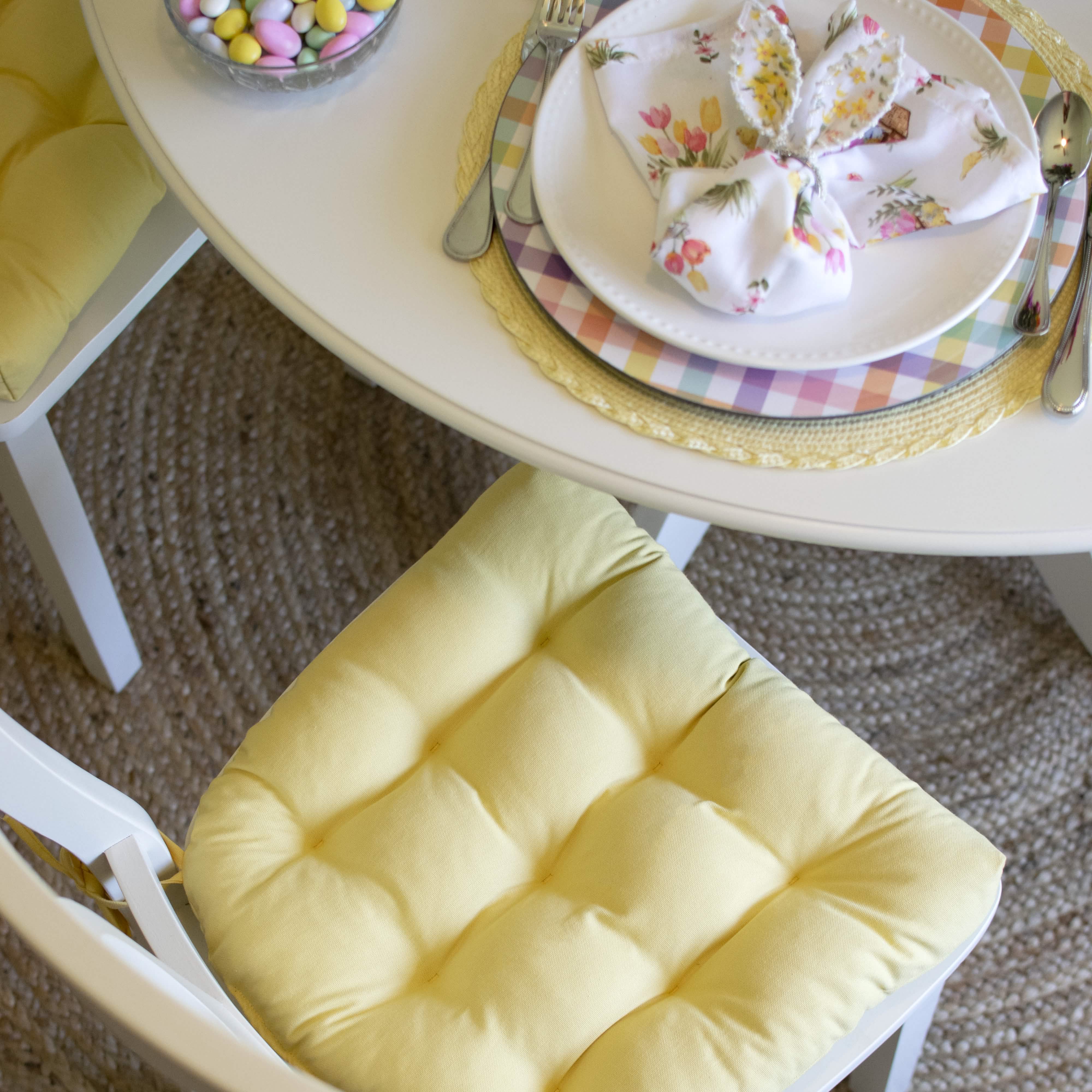 Bright yellow dining chair pad displayed on wooden chair