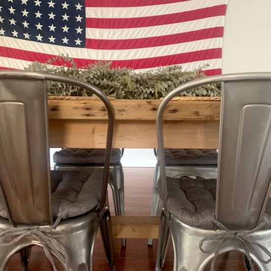 grey linen tolix chair cushions on metal farmhouse chairs with usa flag and rustic dining table