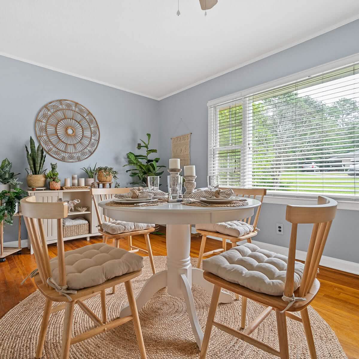 neutral colored dining chair cushions on natural colored wooden dining chairs in boho dining room