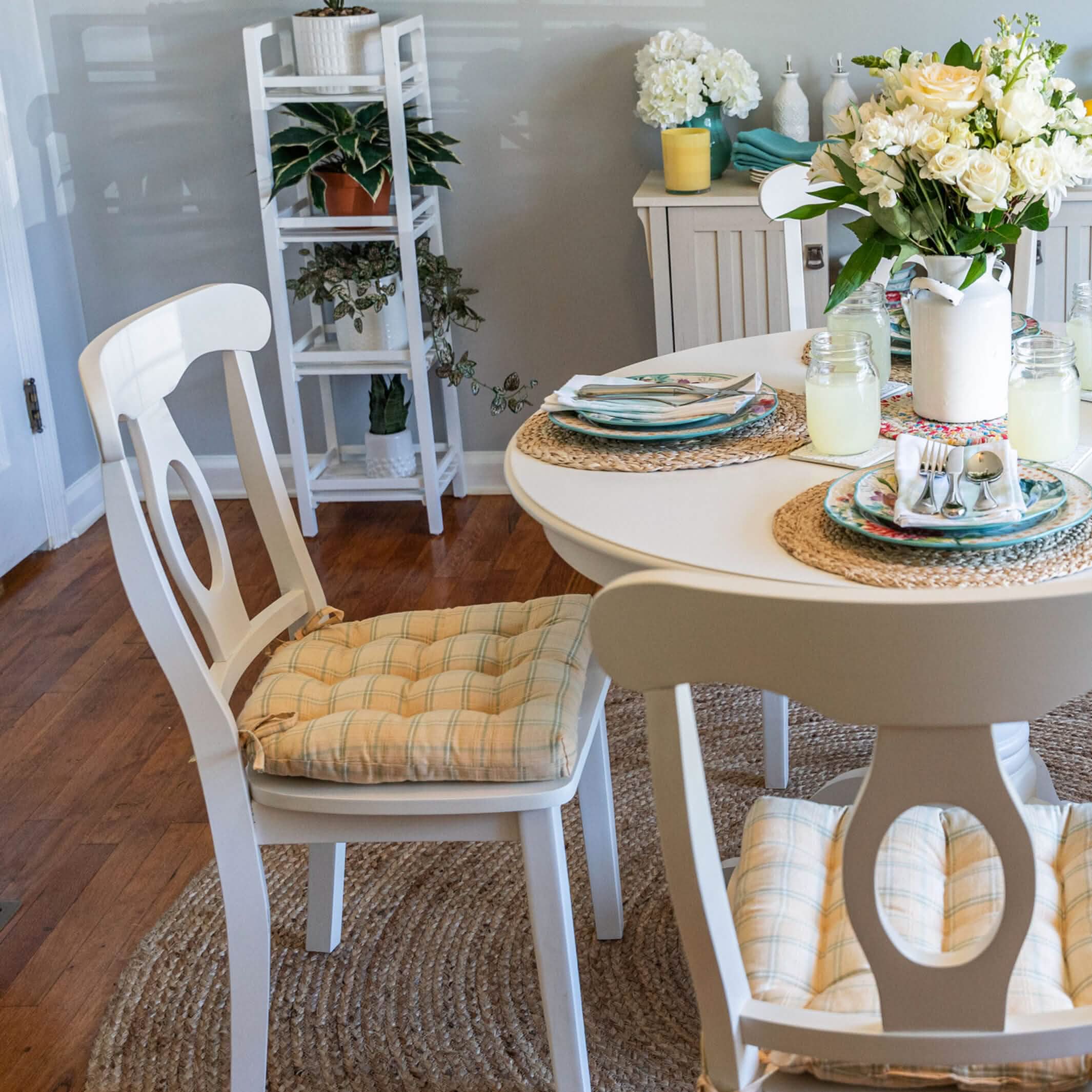 yellow plaid dining room chair cushions with pioneer woman dinnerware in farmhouse kitchen with white dining room furniture and fresh flowers