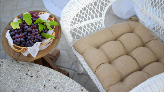 outdoor chair cushion on a white wicker chair on the patio