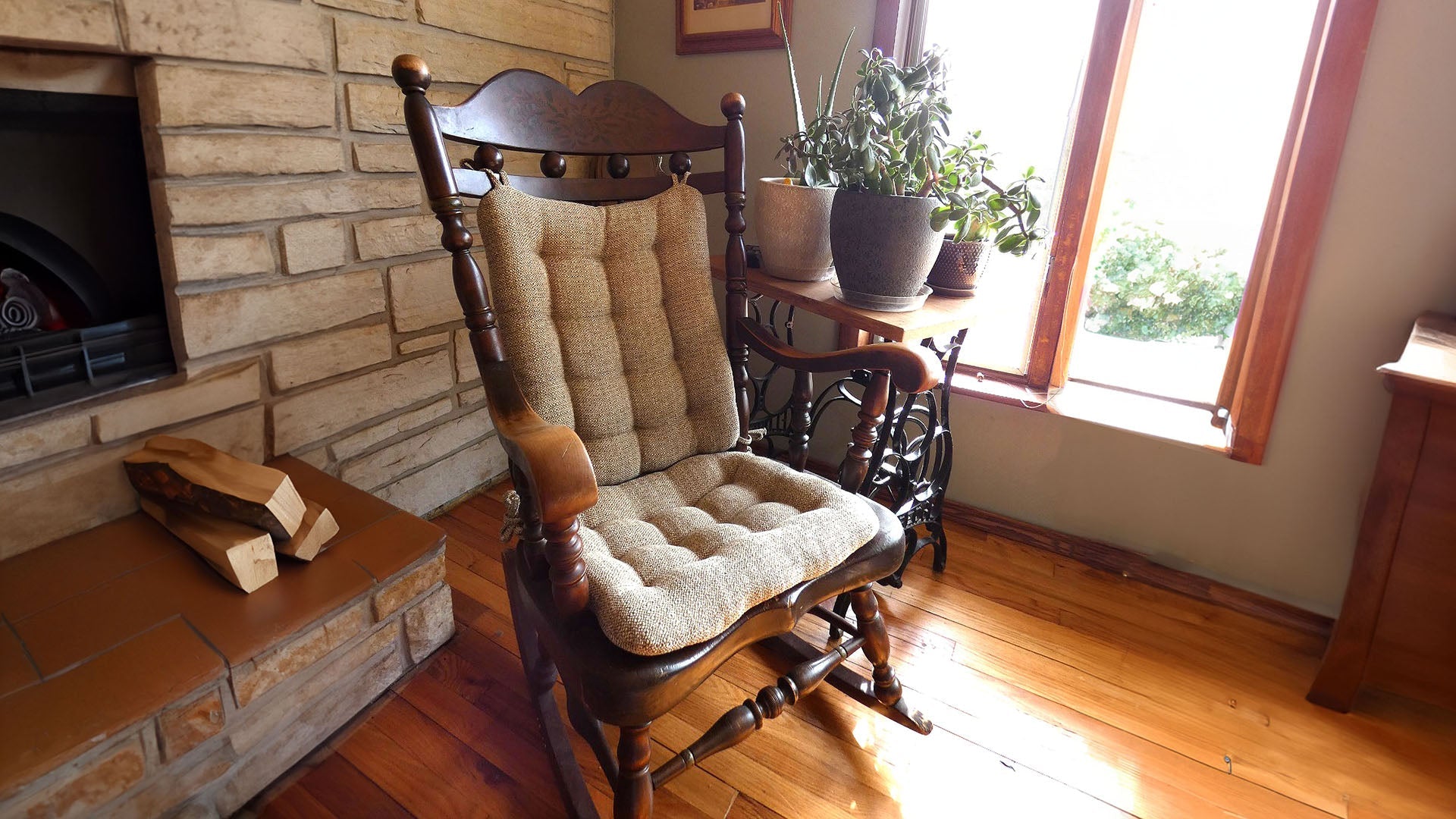 Brisbane Collection rocking chair seat and back cushions tufted textured on a wooden rocker in a sunny room by a fireplace