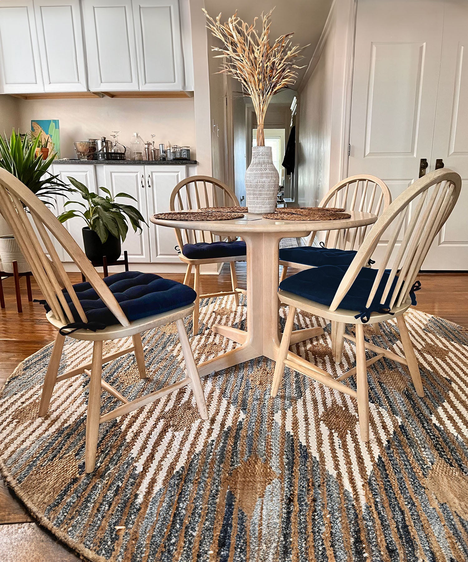 navy blue chair cushions with ties at a round dining table with corduroy dining room chair cushions