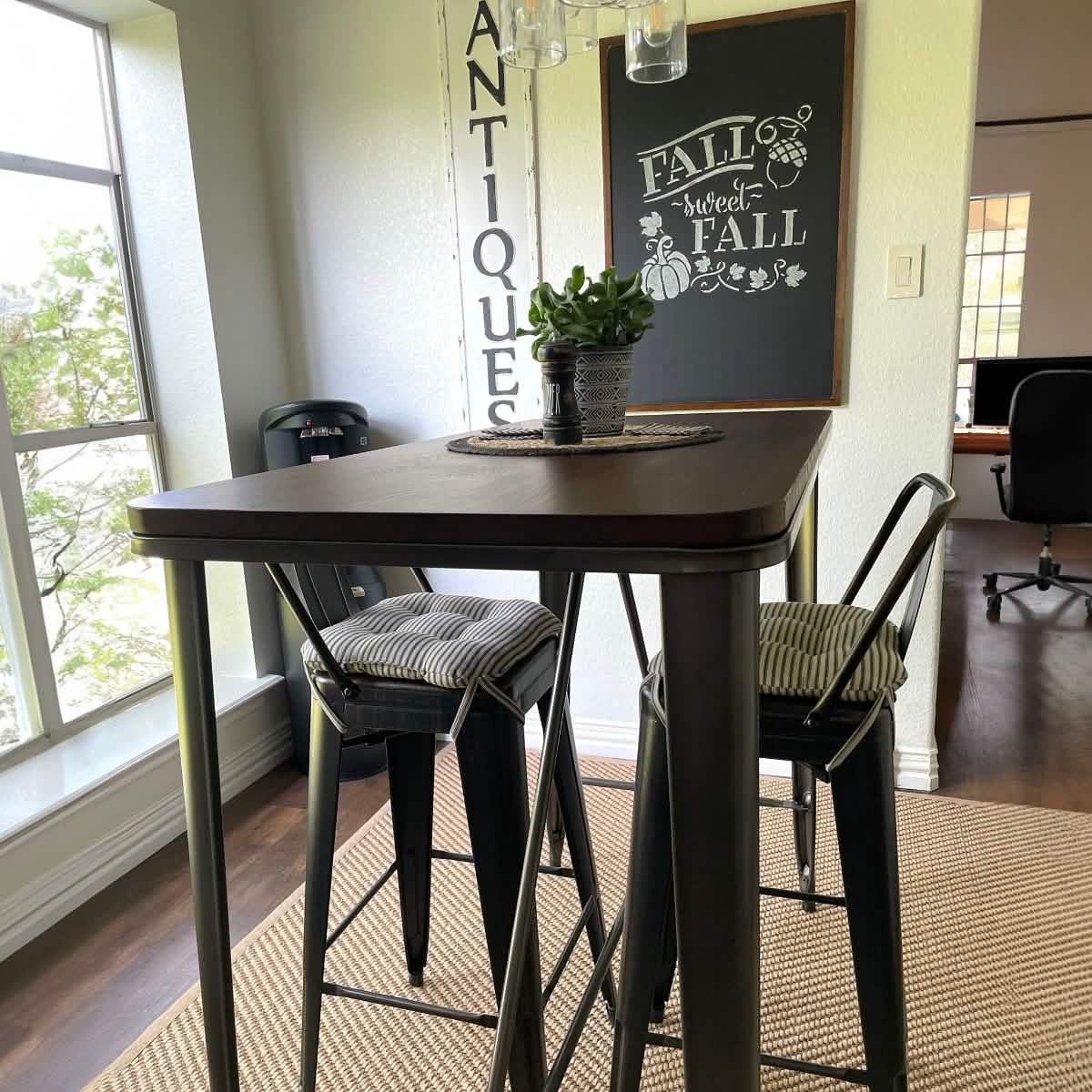 black ticking stripe tolix stool cushions at a bar height cafe table
