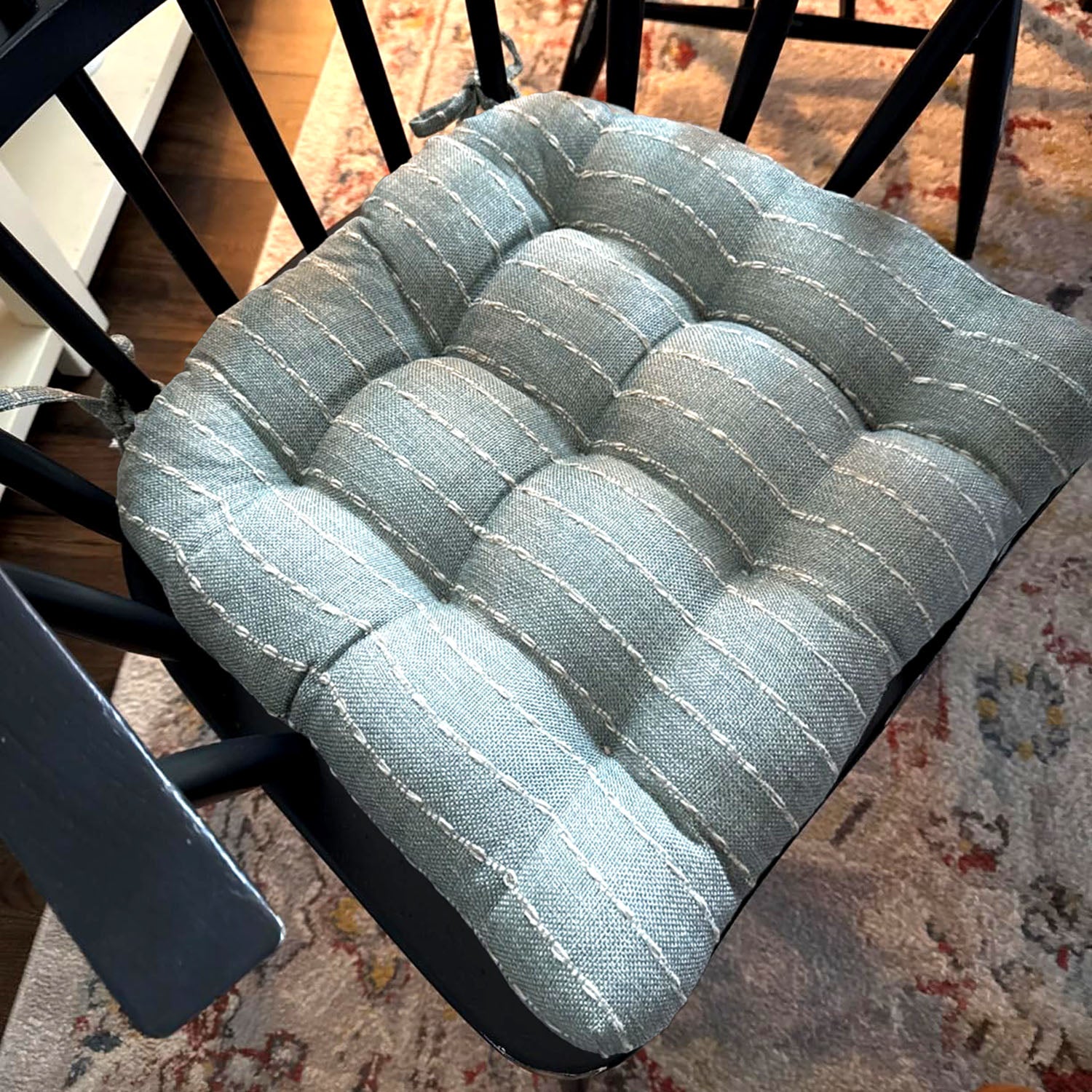 Close up of avante spa dining chair cushion on black chair.