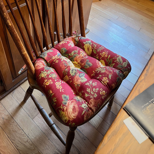 red floral dining chair cushions on windsor chair at traditional dining room table