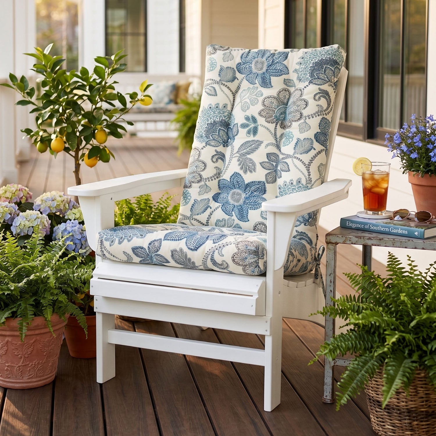 blue floral adirondack cushions on a white polywood adirondack chair on the porch of a southern home