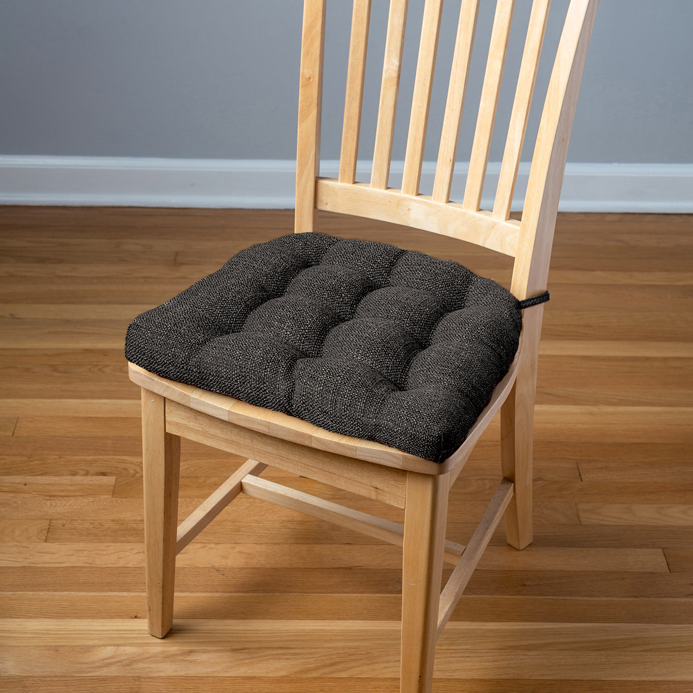 black tweed dining chair pad on natural dining chair