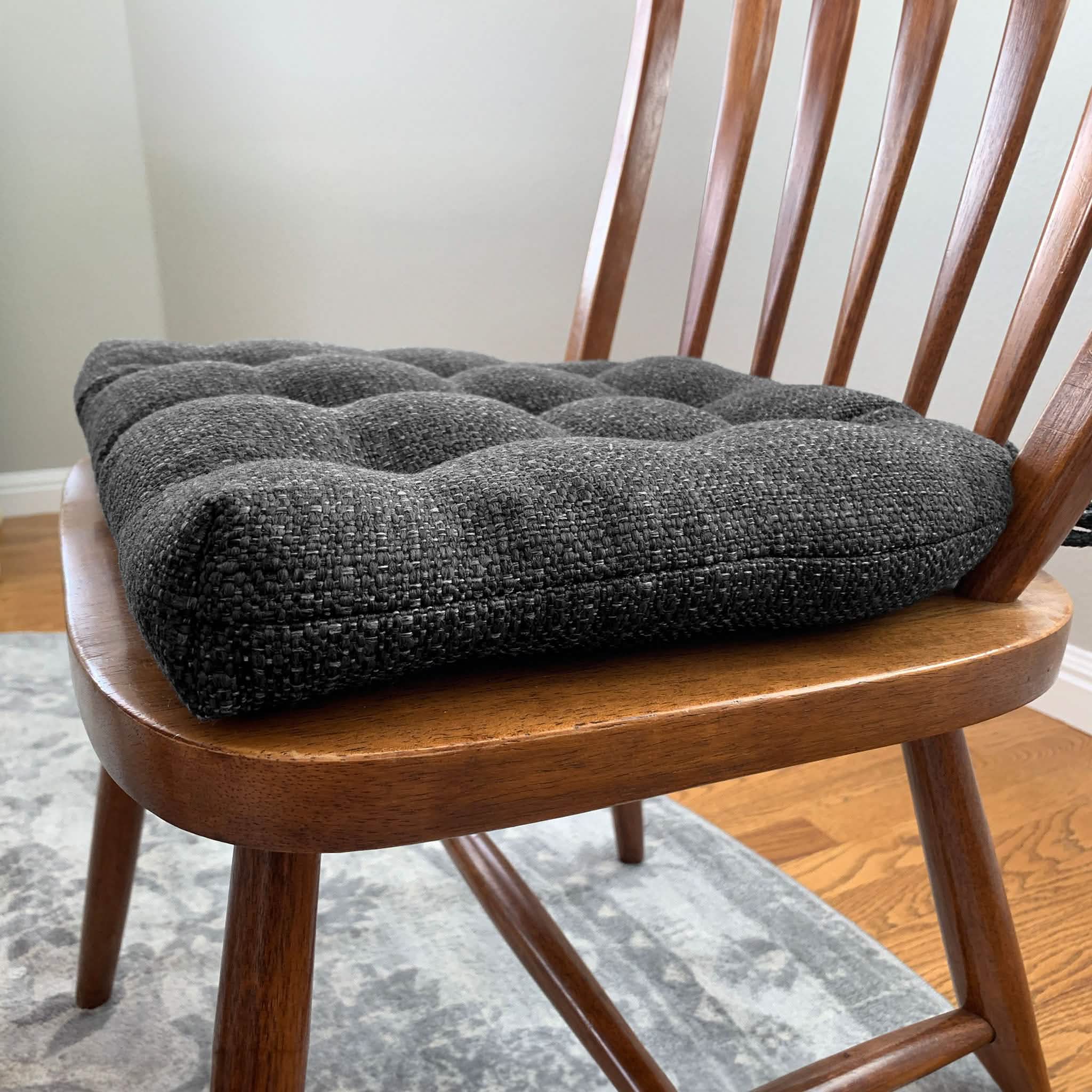 Close-up detail view of Brisbane charcoal black dining chair pad showing texture and quality