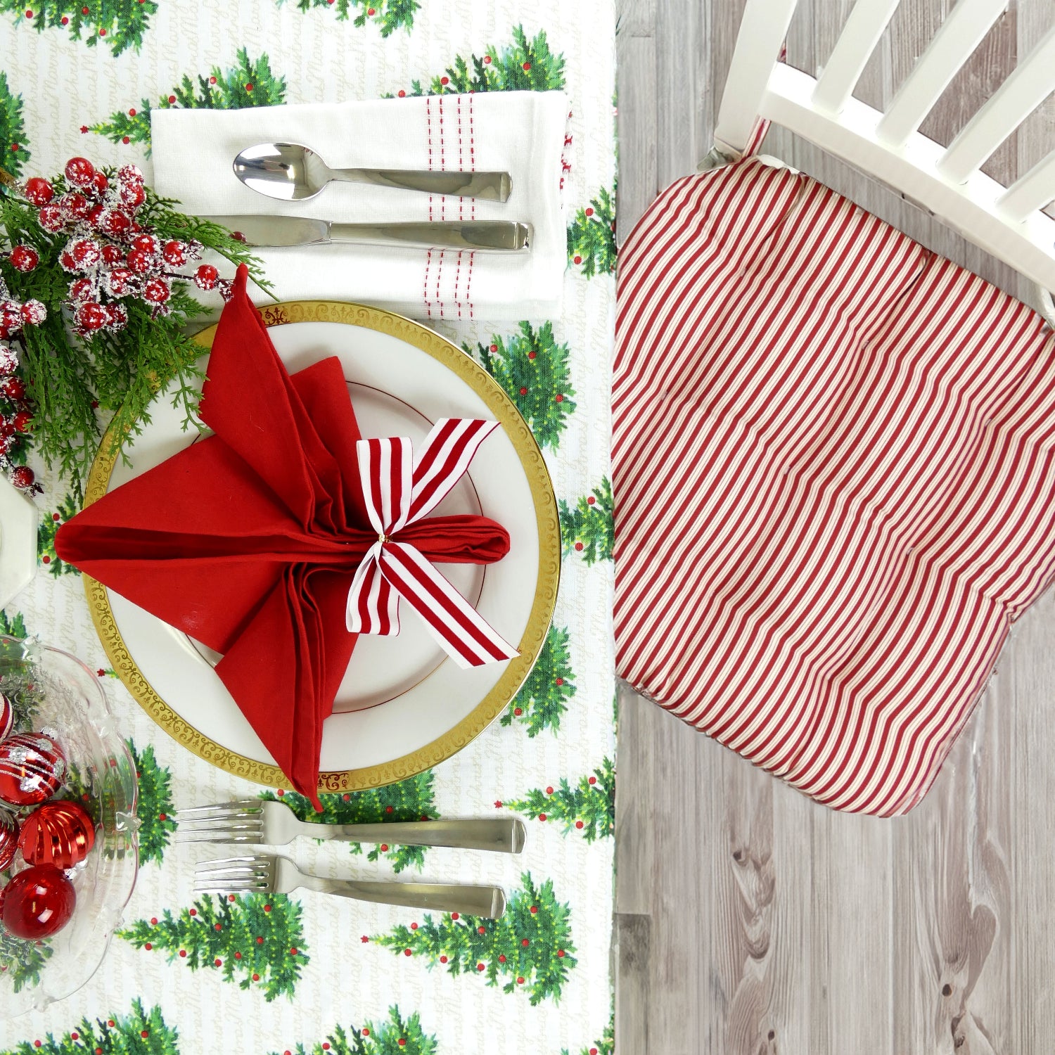 peppermint candy cane striped chair cushions at christmas dining table with matching cloth napkins
