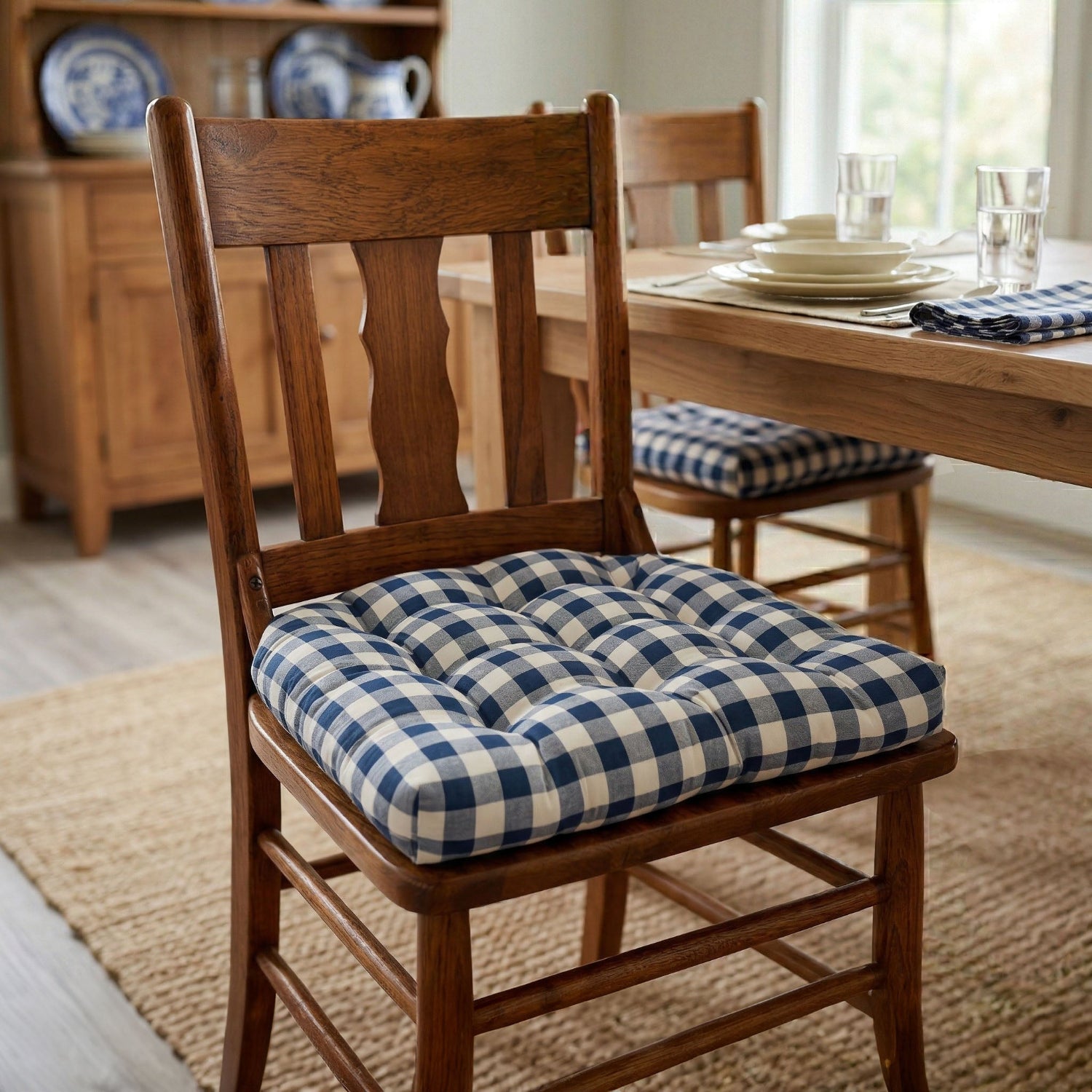 Wooden chair with a blue and white checkered cushion in a dining room setting.