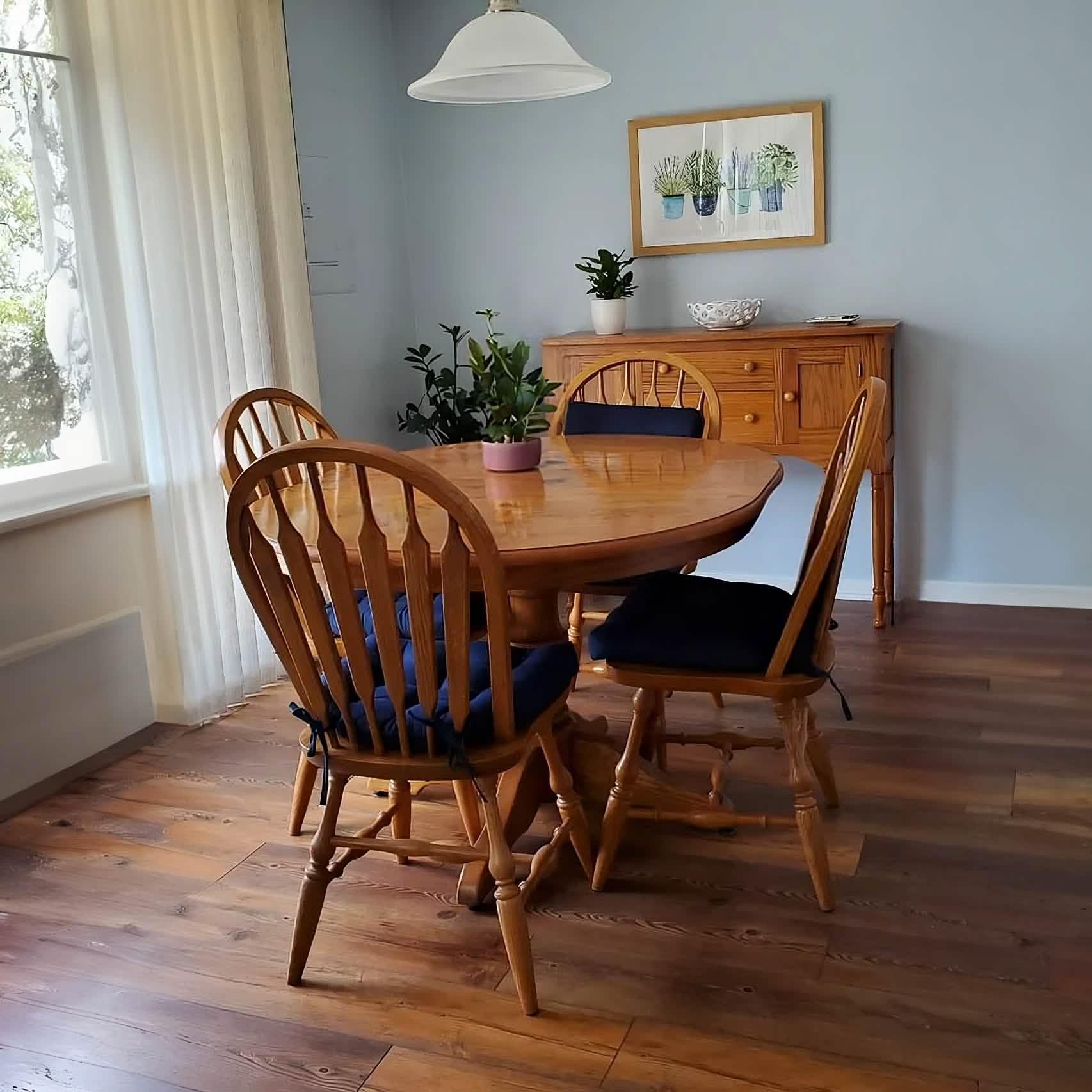 Navy blue dining chair cushions on wooden chairs around farmhouse dining table