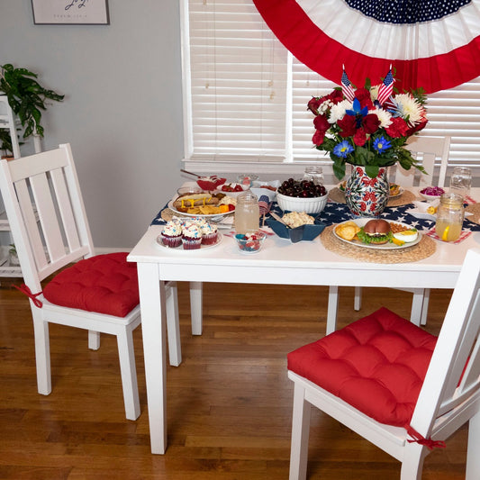 red cotton dining room chair cushions on white dining chairs at farmhouse table set for independence day celebration