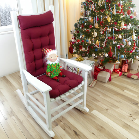 wine red rocking chair cushions on a white rocker in a living room decorated for christmas