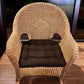 brown wicker chair cushion on rattan armchair