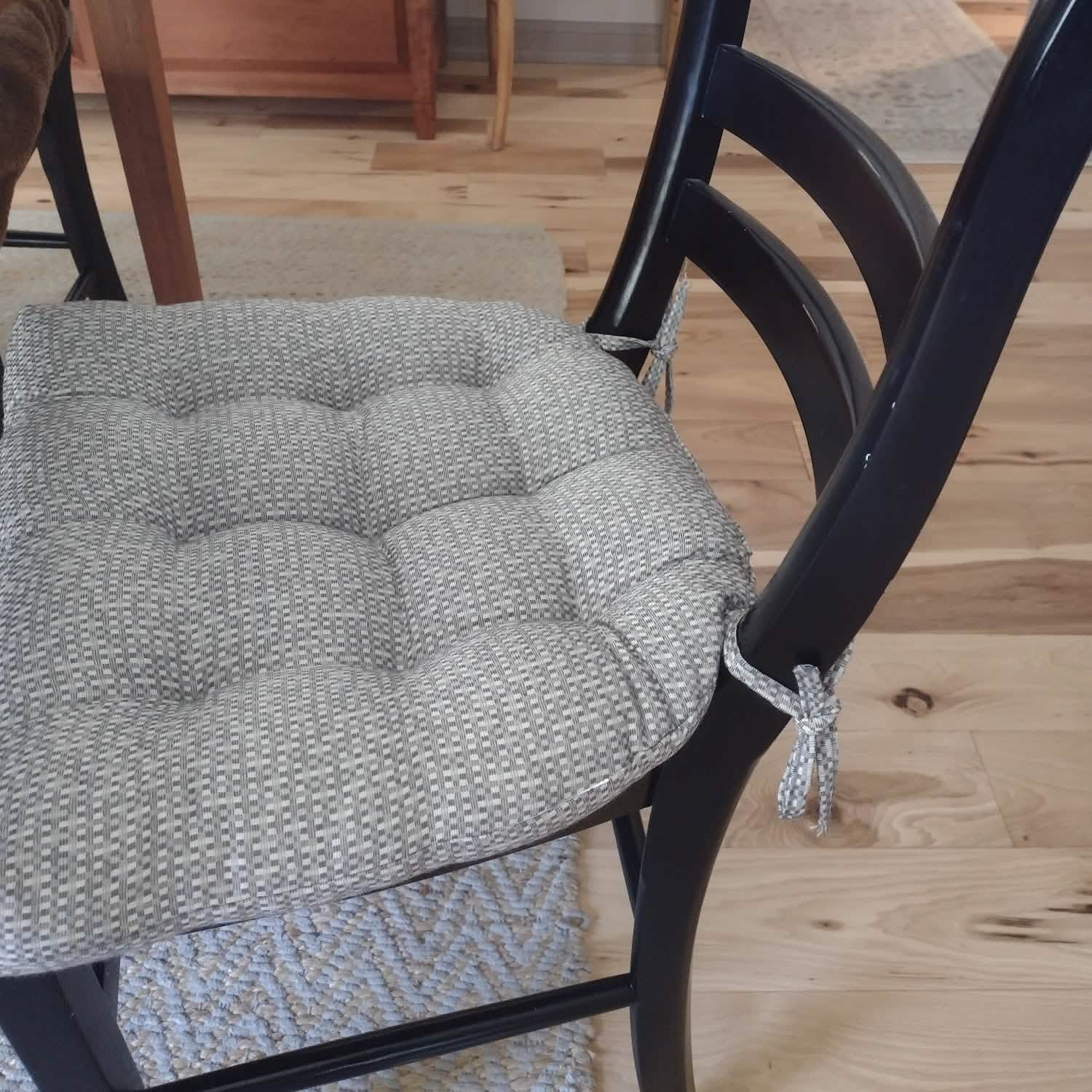 Close-up view of June Grey dining chair cushions showing fabric texture and quality