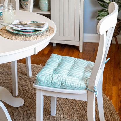 aqua gingham chair pads on white dining chairs in farmhouse kitchen