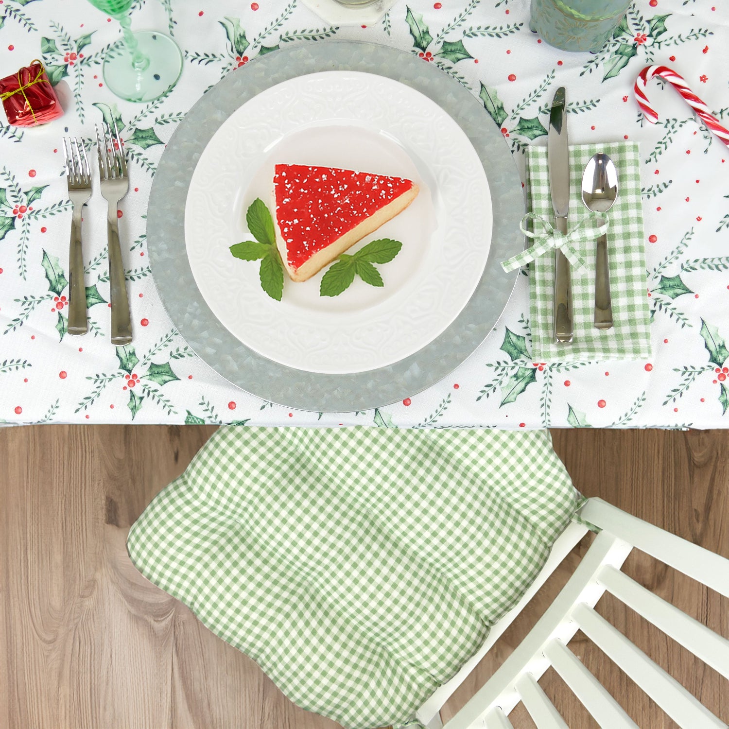Christmas-themed table setting with christmas dining chair cushion and matching napkin and festive decor