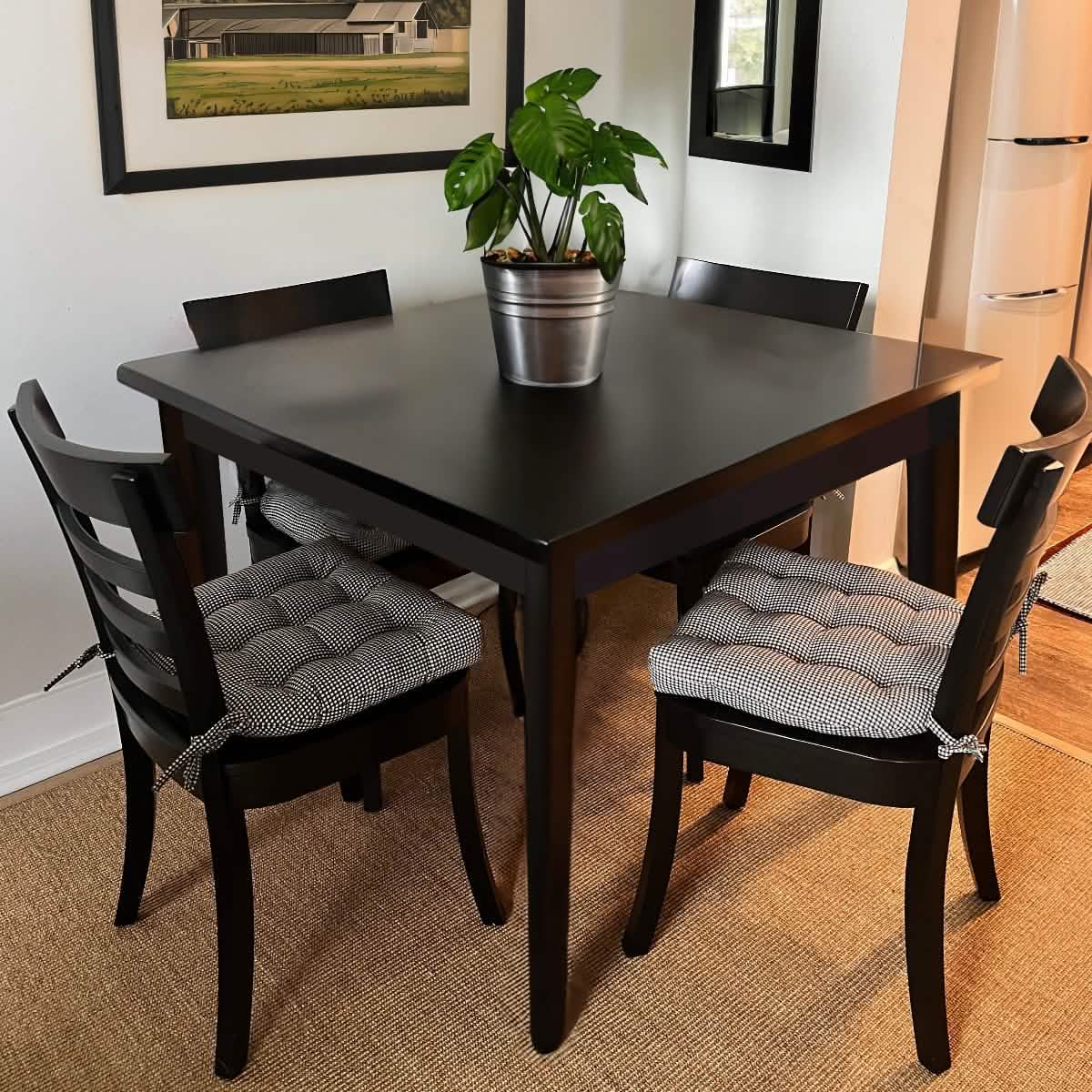 black gingham dining chair cushions at a black kitchen table with black and white checks