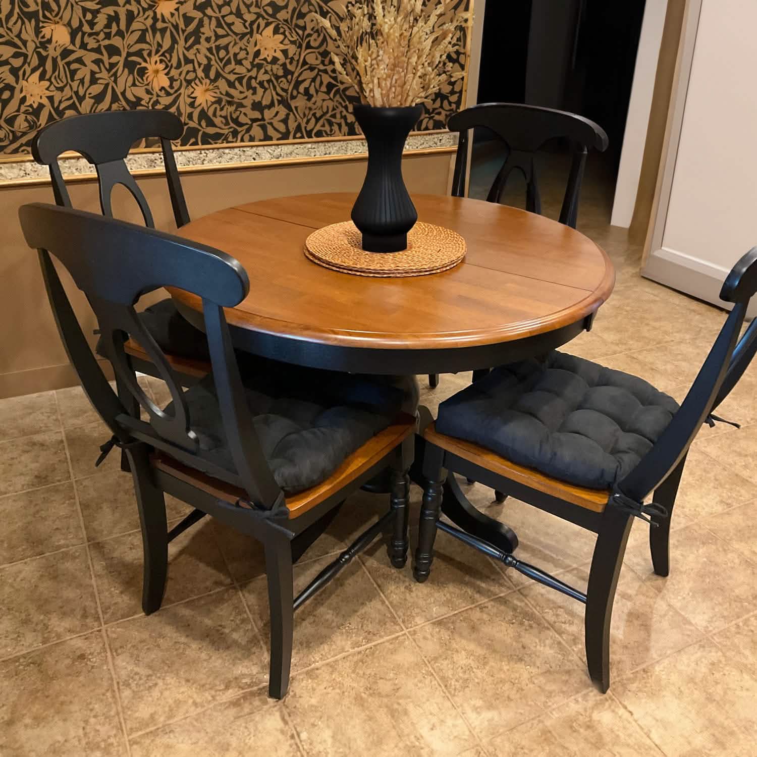 Black chair pad secured to wooden dining chair with ties