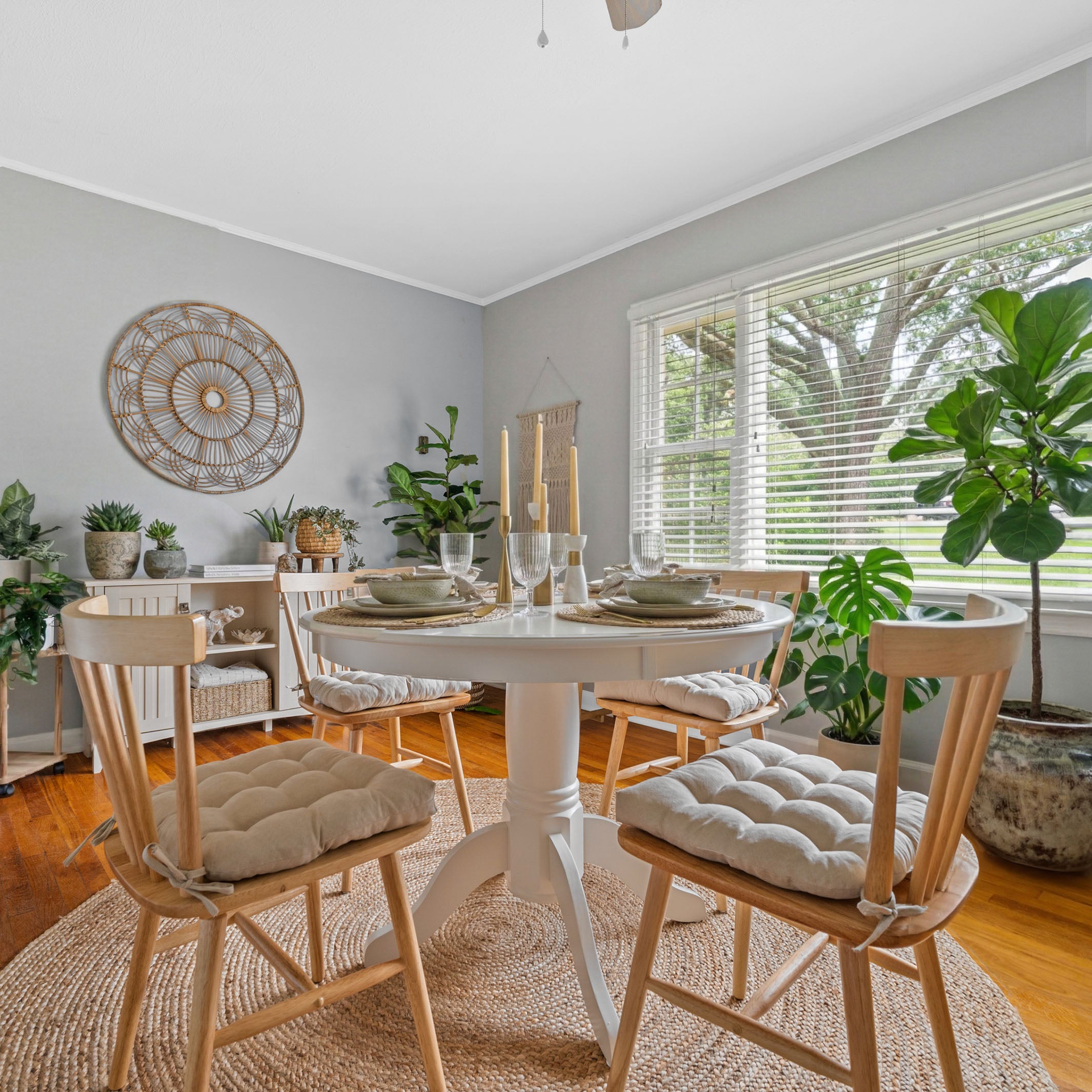 neutral colored dining chair cushions on natural colored wooden dining chairs in boho dining room
