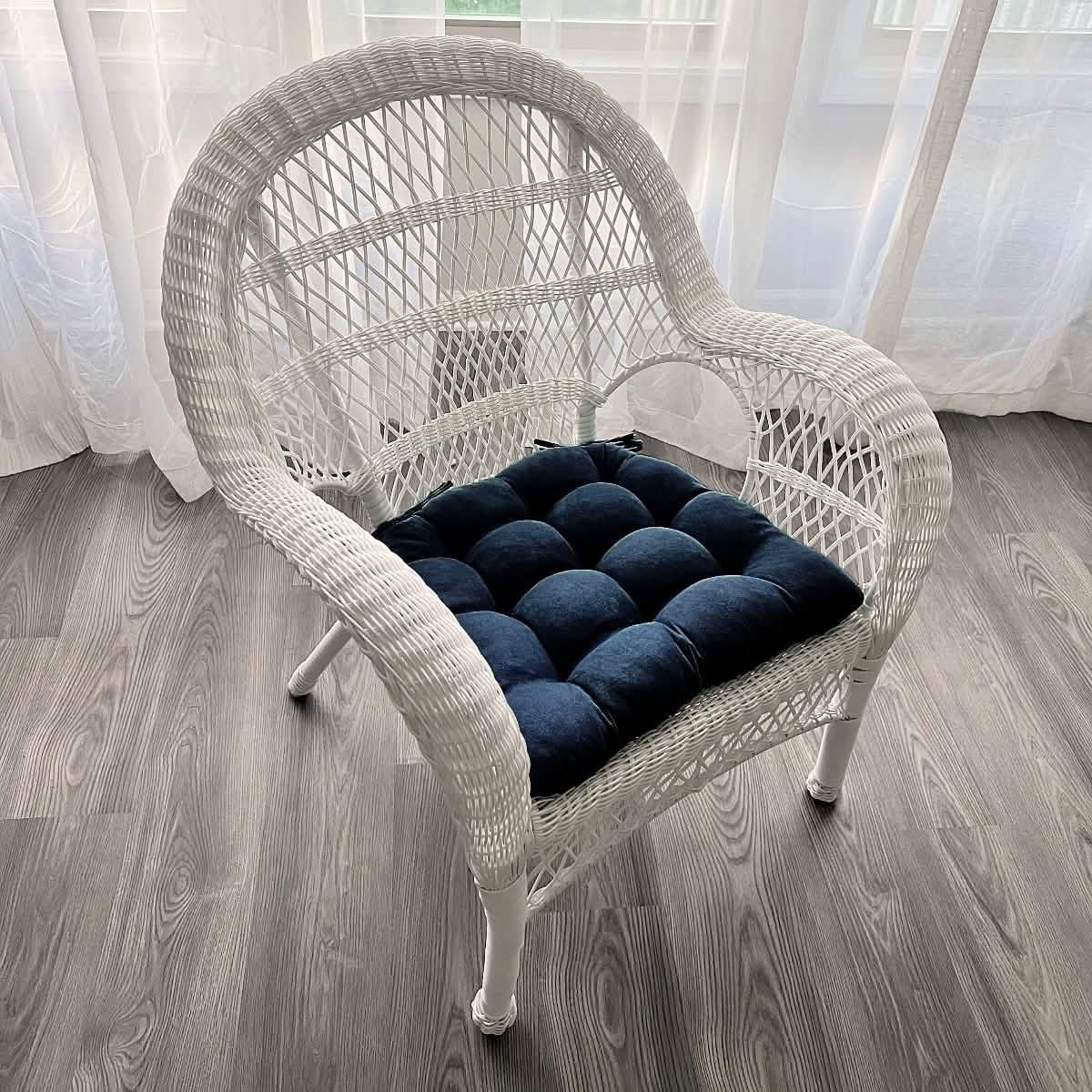 microsuede royal blue cushion on white wicker chair