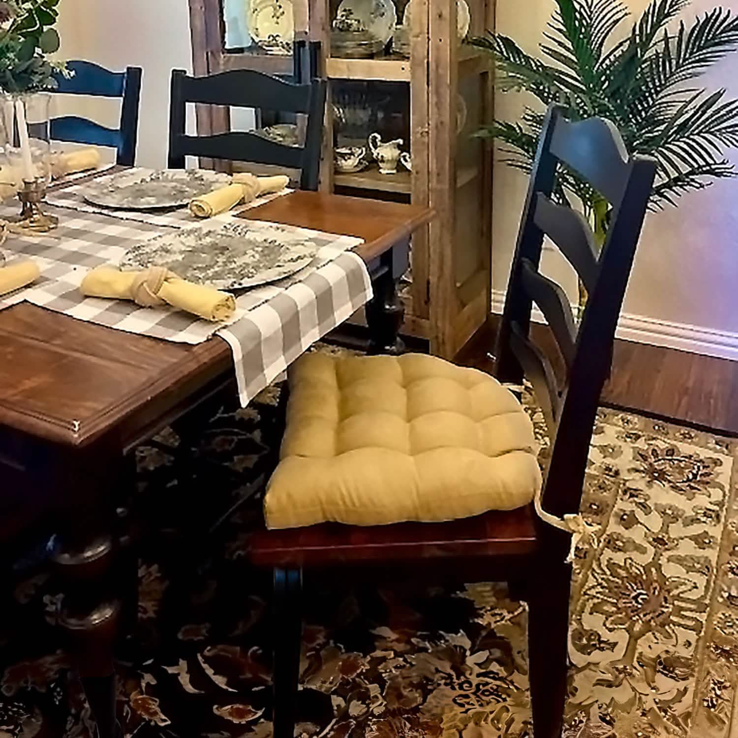 microsuede camel dining chair cushion on wooden chair at dining room table.