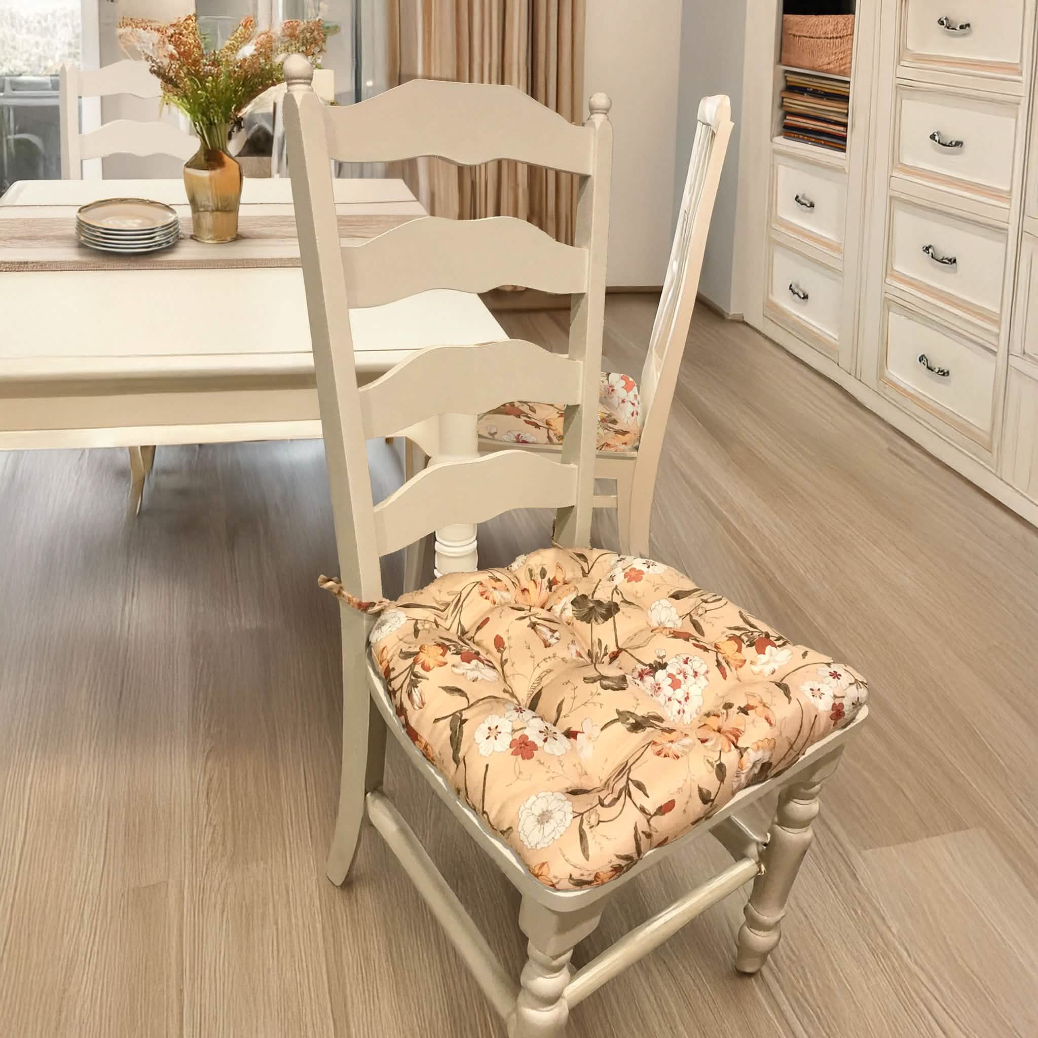 Mimosa floral dining chair cushions styled on wooden dining chairs in home setting