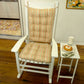 peach rocking chair cushion set on a wood rocker in a contemporary living room
