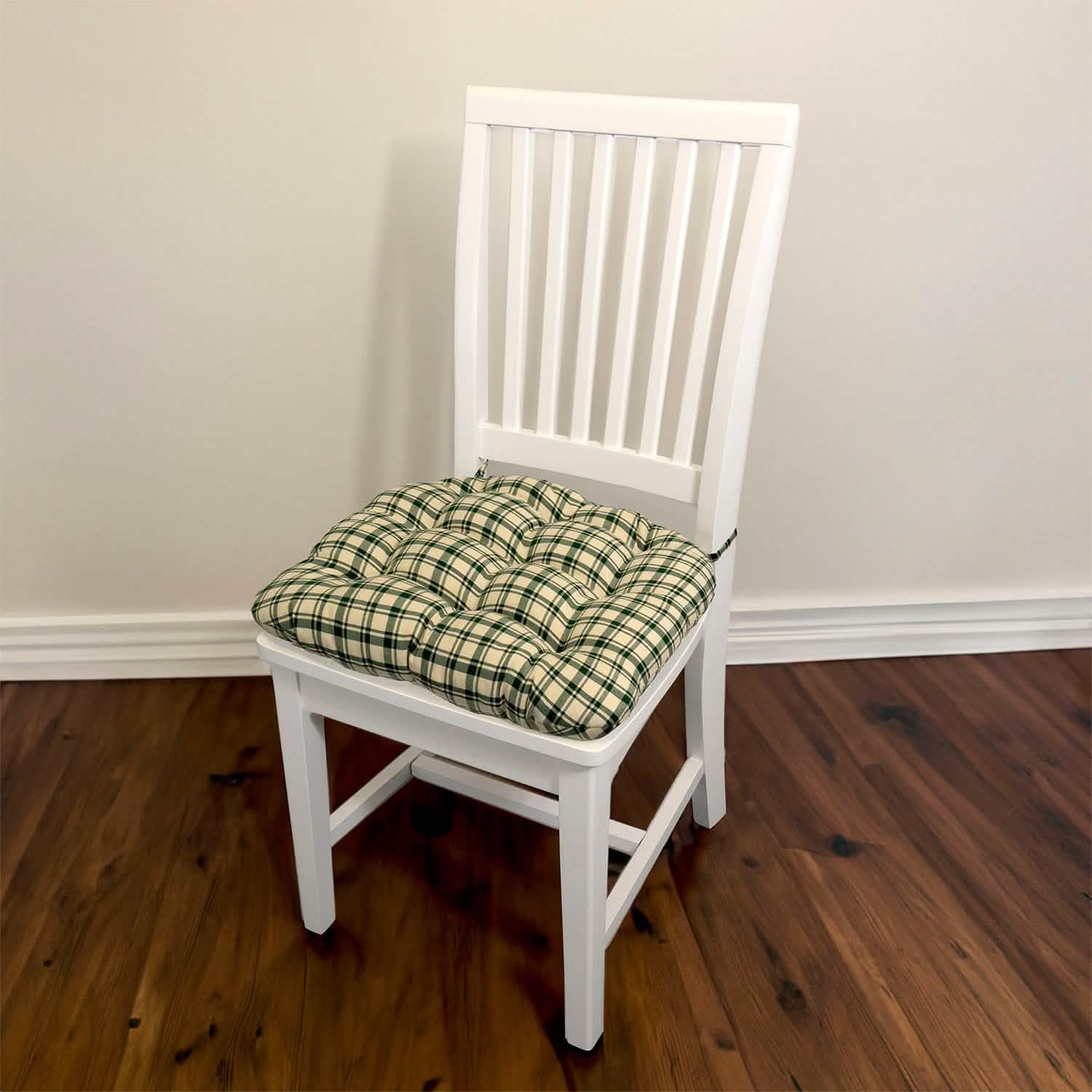 Montgomery Green plaid dining chair cushions styled on wooden chairs in casual dining room setting