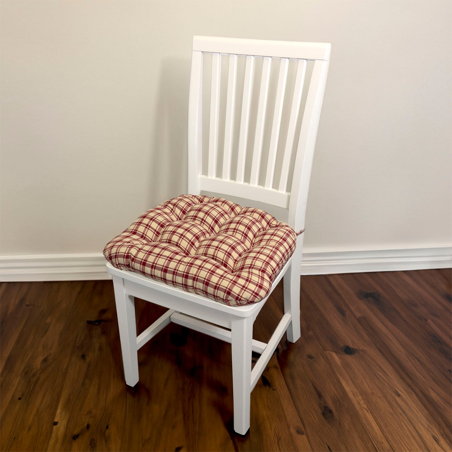 red plaid chair pads with ties on white dining chair in traditional dining room