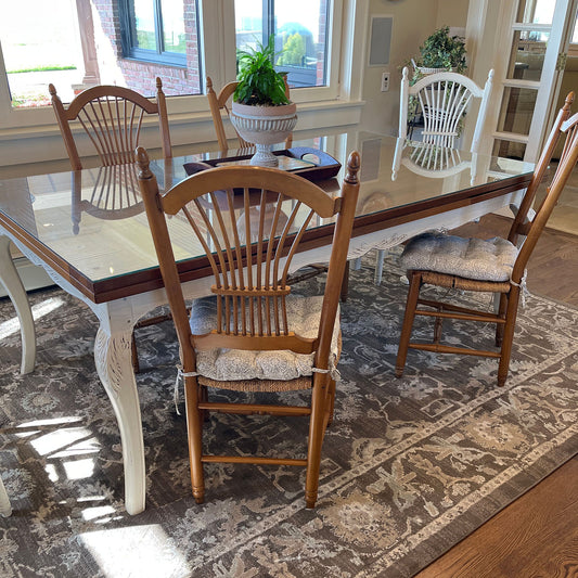 light grey dining chair cushions on cane seat dining chairs in transitional dining room