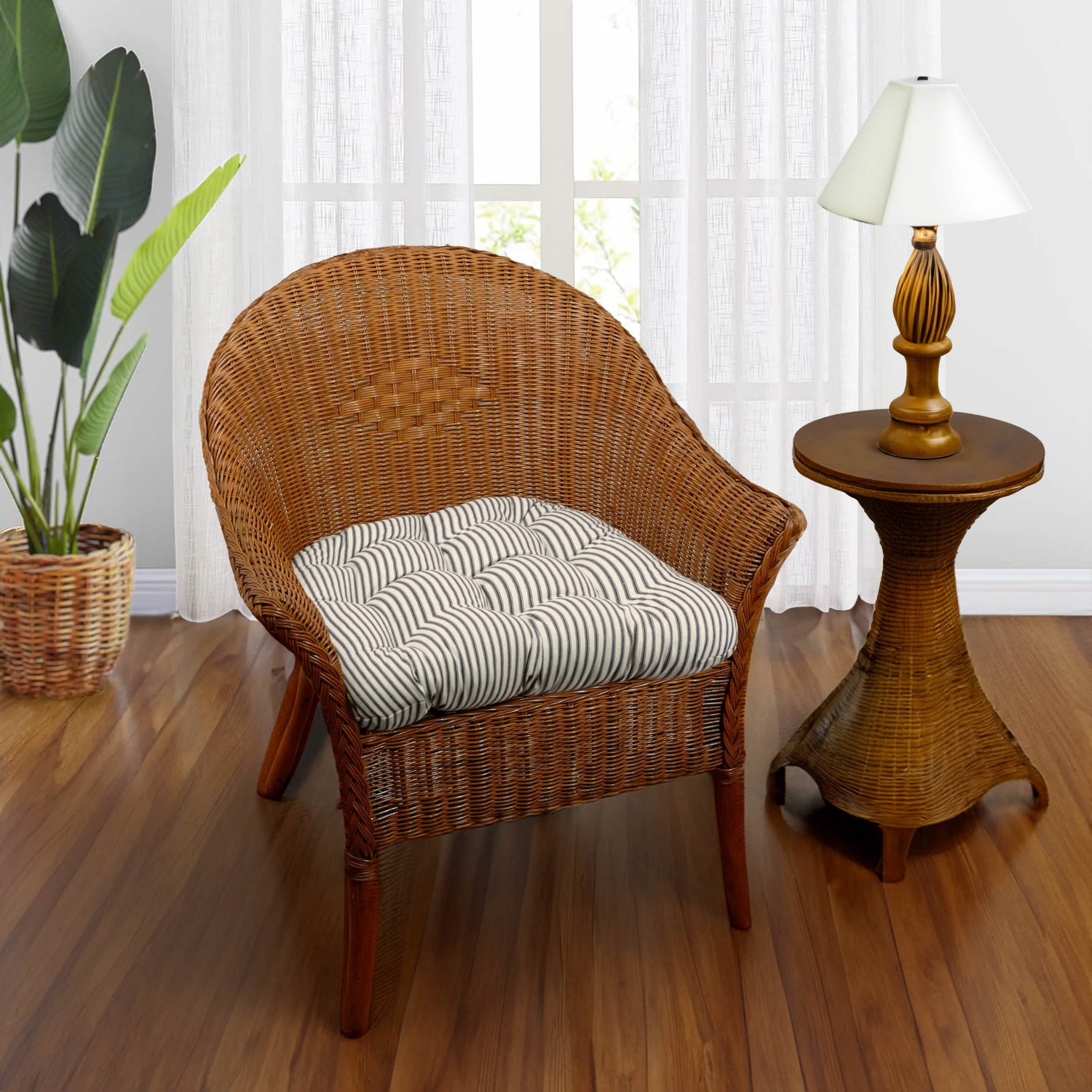 black striped wicker chair cushion on a rattan armchair