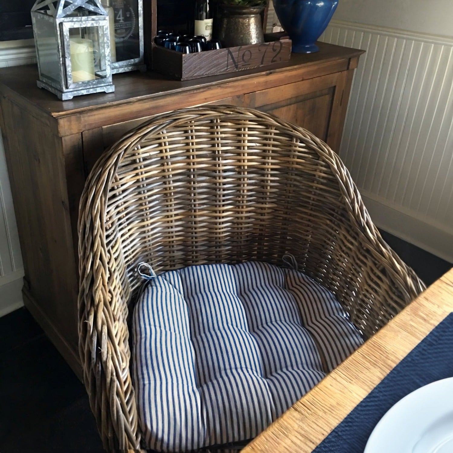 navy ticking stripe wicker chair cushions on a rattan chair in the dining room