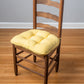 Extra thick welted yellow cotton duck chair pad on brown dining chair