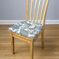 blue and white floral dining chair cushions on natural dining chair
