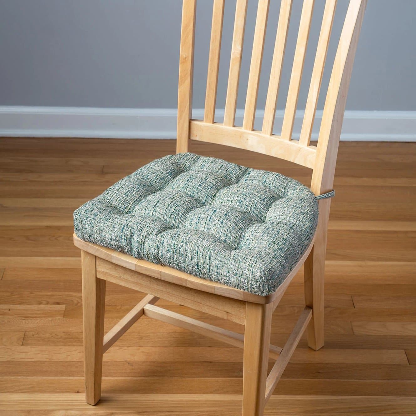 seaglass colored dining chair cushions on natural wood dining chair