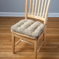 wheat colored dining chair pad in tweed pattern fabric on wooden dining chair